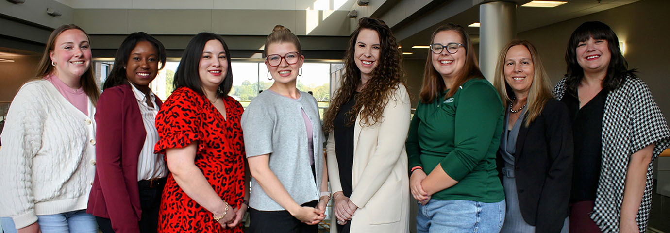seven students posing with instructor for group photo