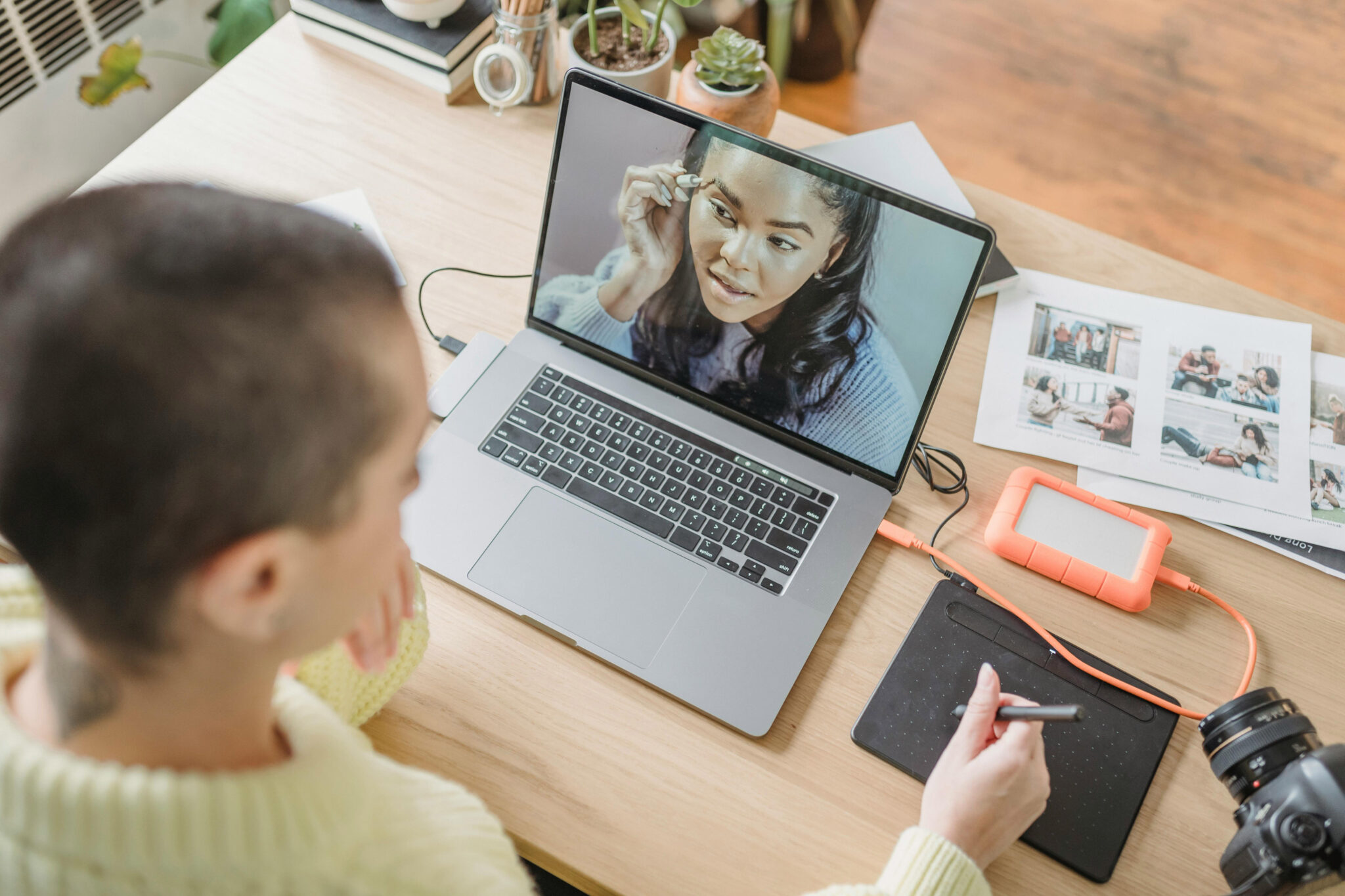 student using tablet and laptop to edit video